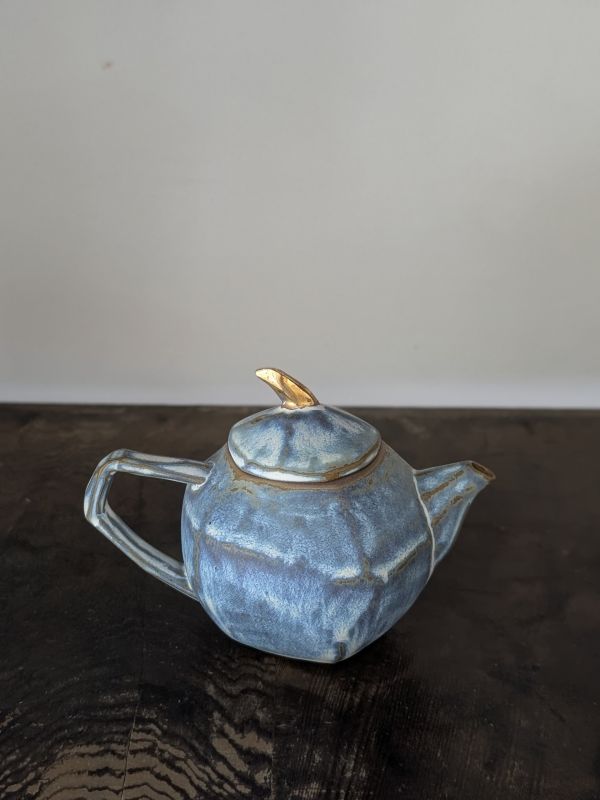 吳慧芳 ｜金鈕藍墨 茶壺 《形式之外 Beyond Form》｜吳慧芳 個展
 
當器物不再服膺傳統形式,
創作的秩序,是否能從土裡自由生長？
來自苗栗、深耕陶藝十五年的創作者吳慧芳,長年研習絞胎技法與釉色配製,於火與土之間累積數百次窯燒經驗。此次個展,她選擇放下過往熟悉的節奏與邏輯,以全新釉色與形式語彙,展開一次更靠近內在感知的創作轉身。