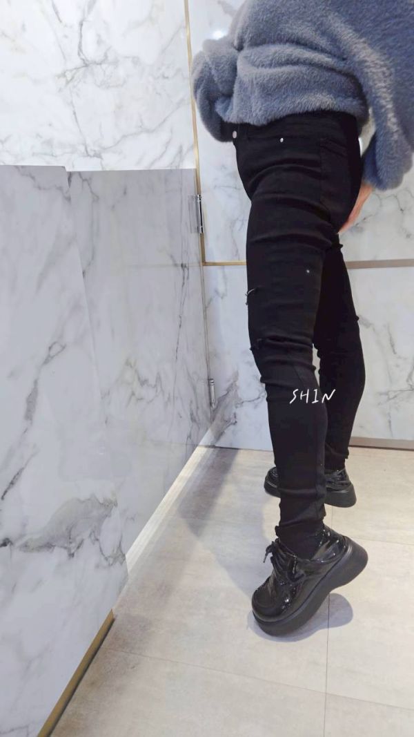 一顆釦割破黑色牛仔褲 