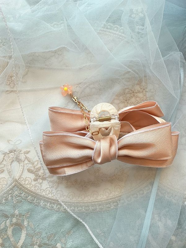 粉色素面垂墜小花蝴蝶結抓夾 