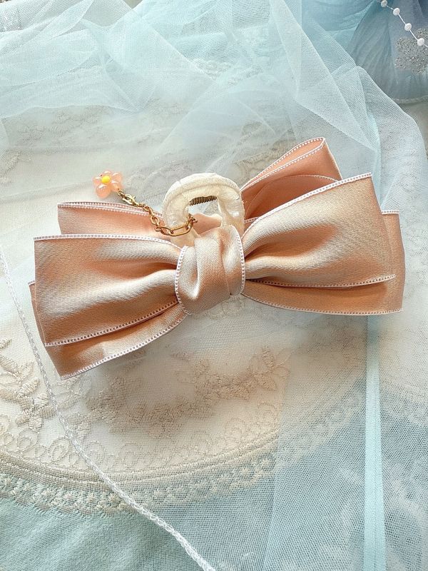 粉色素面垂墜小花蝴蝶結抓夾 