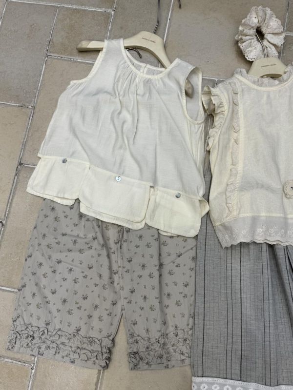 米色不規則下擺貝殼釦背心 